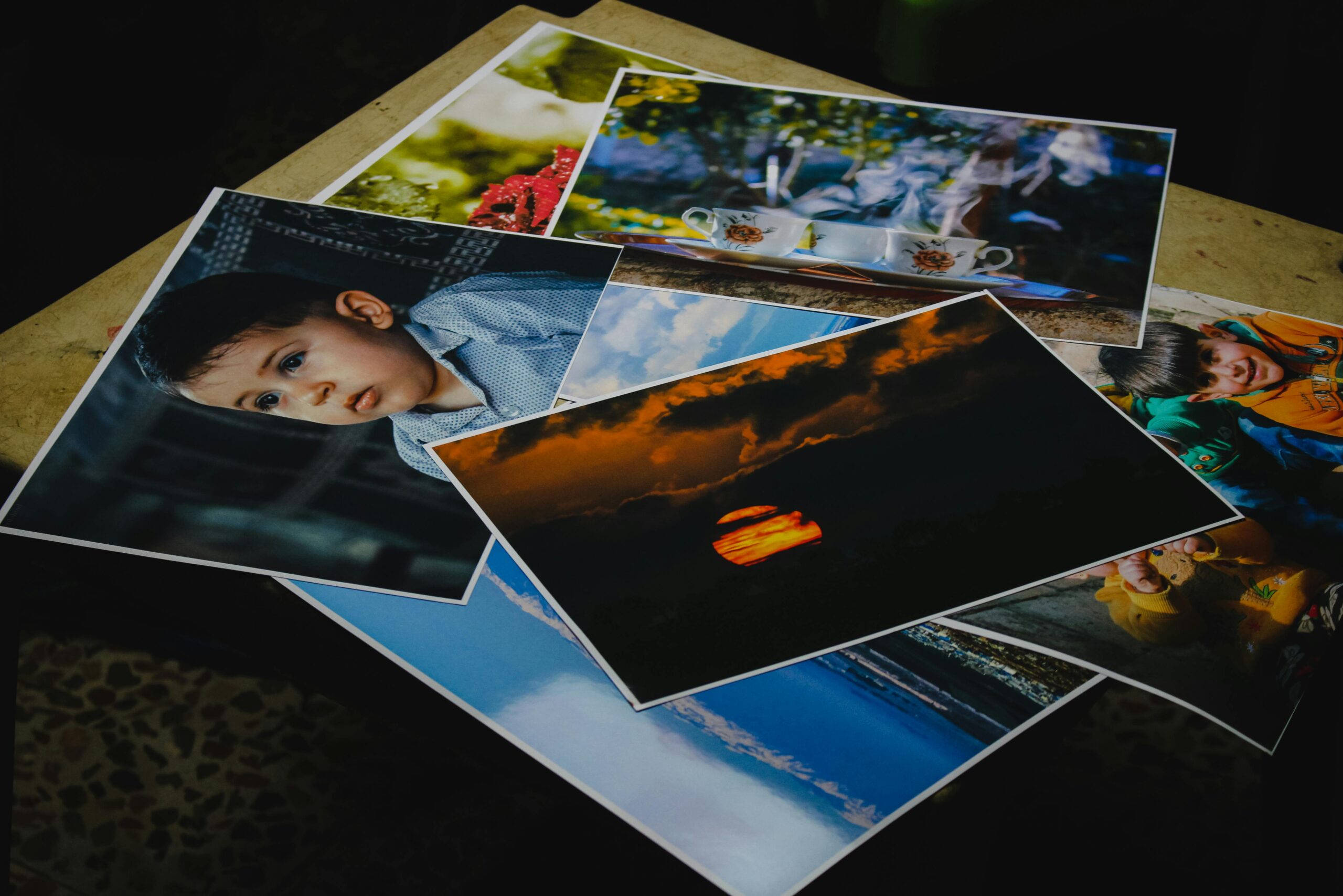 Collection of printed photographs featuring various subjects and moods.